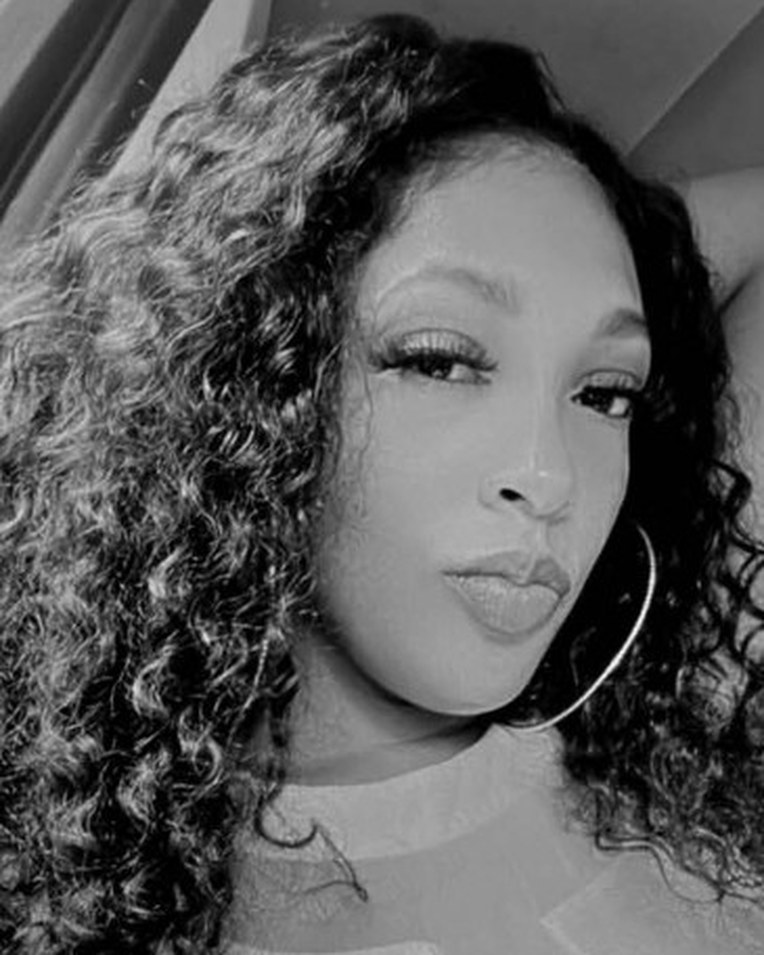 Black-and-white portrait of Chelly Clark with long curly hair