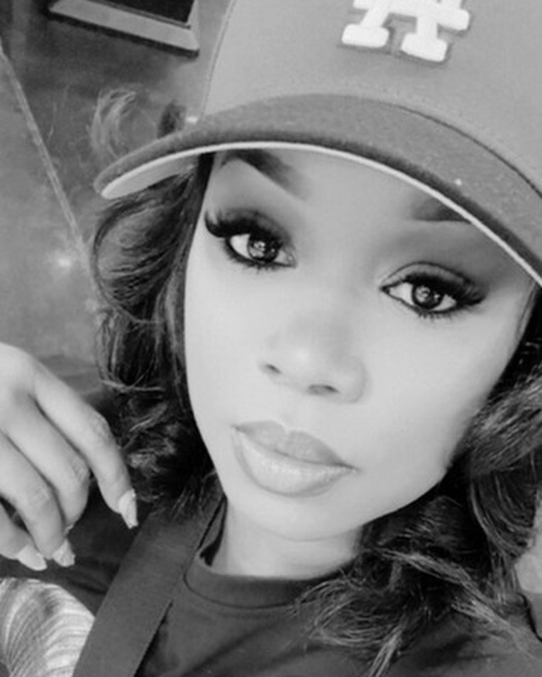 Black-and-white portrait of Janaya in an LA cap